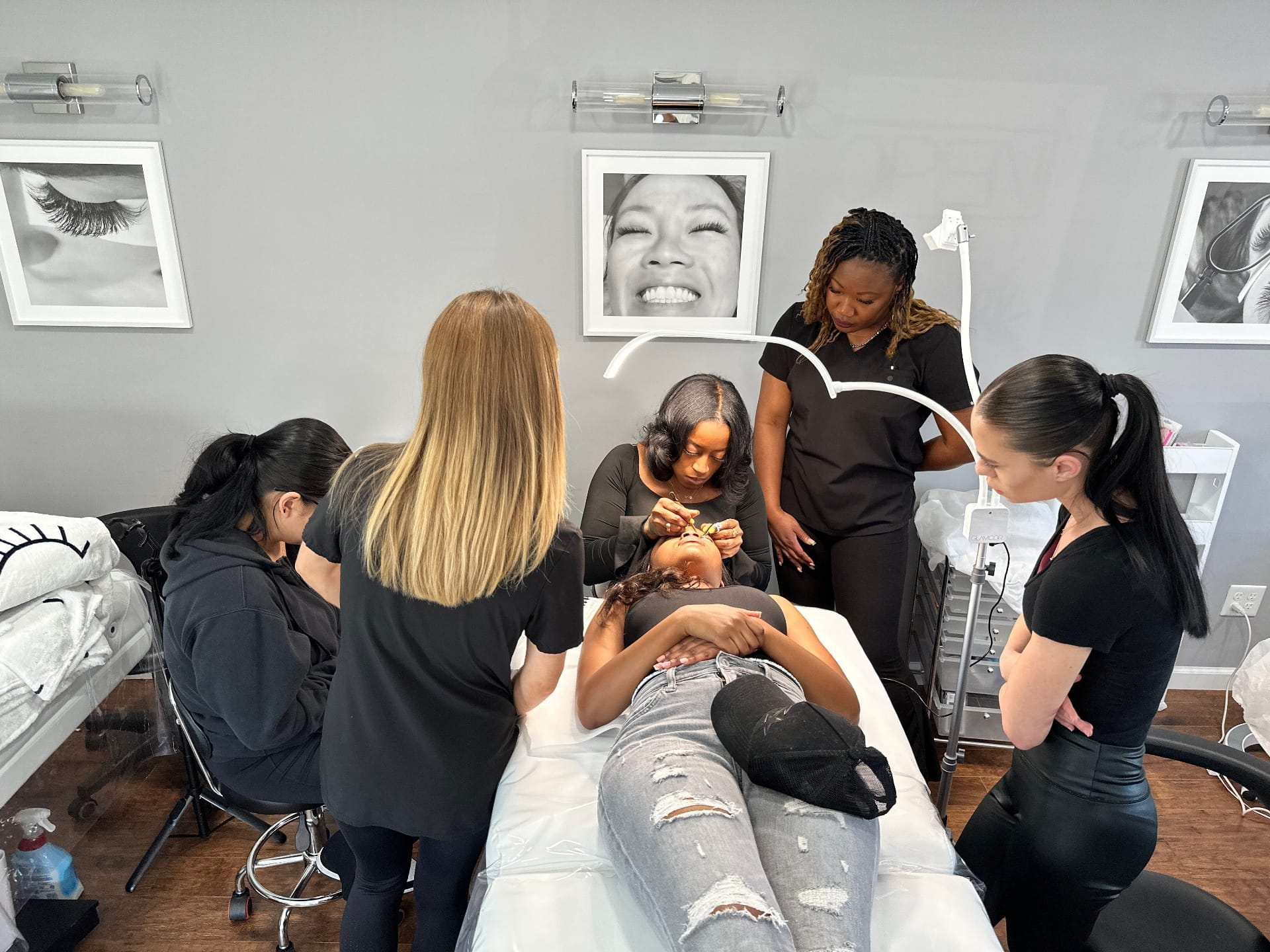 Hands-on lash training class at Lash Box Syosset with instructor Melesia DeChiaro and students practicing lash extension techniques
