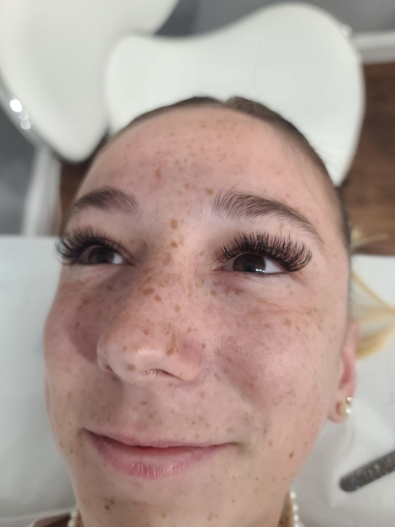 Happy student showing lash extension results from training