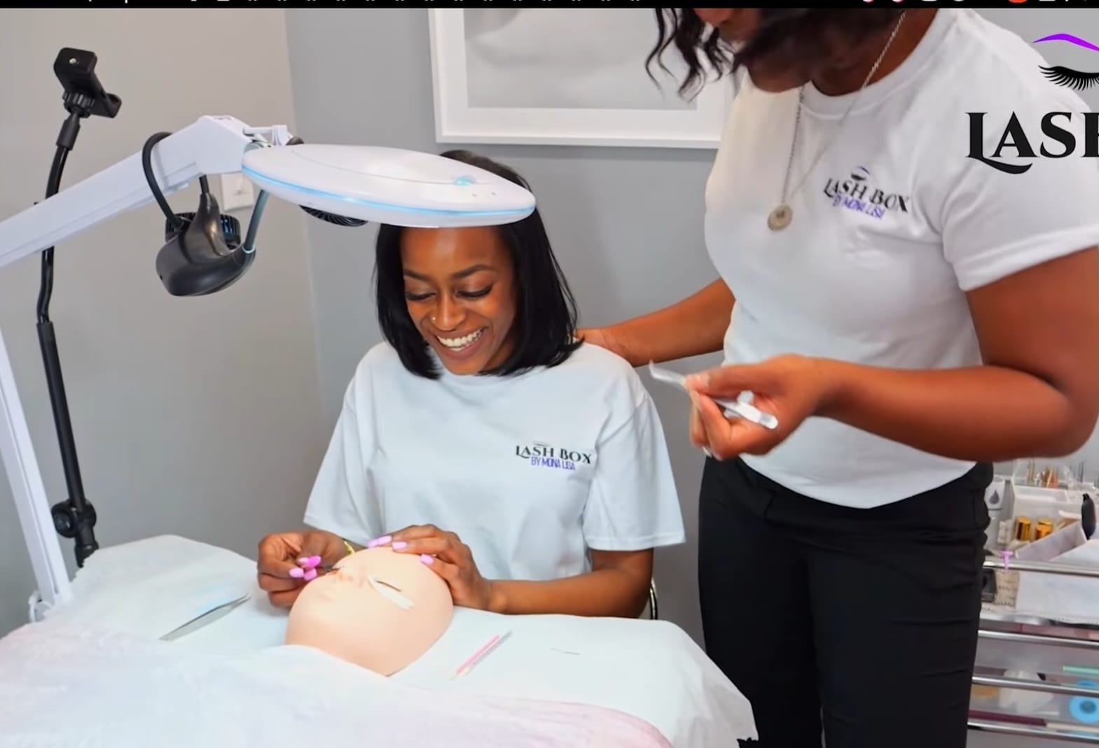 Student practicing lash application on mannequin during training at Lash Box Syosset
